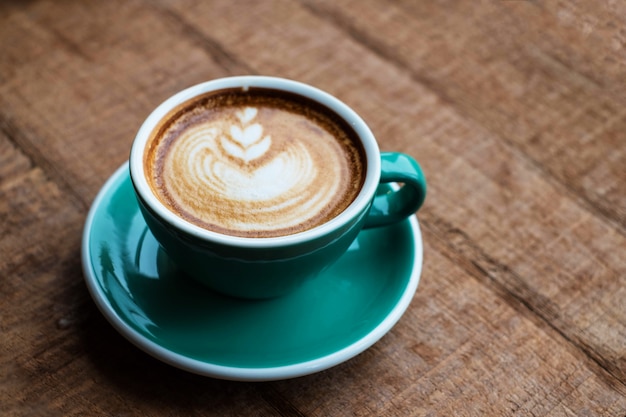 Photo hot art latte coffee on wood table