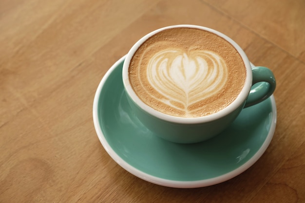 Hot art latte coffee on wood table
