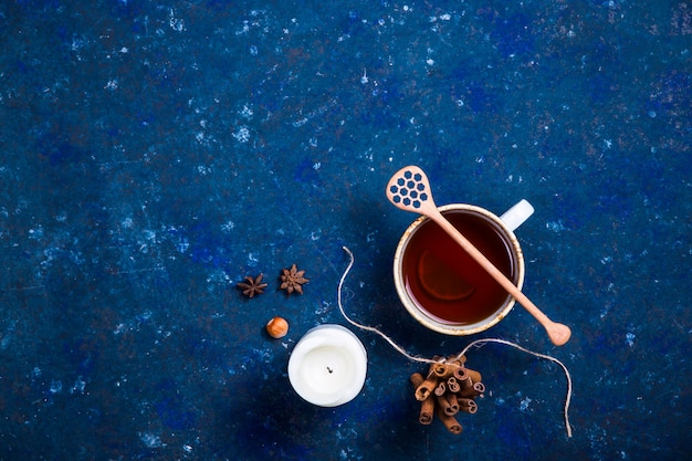 Hot autumn drink on a dark blue