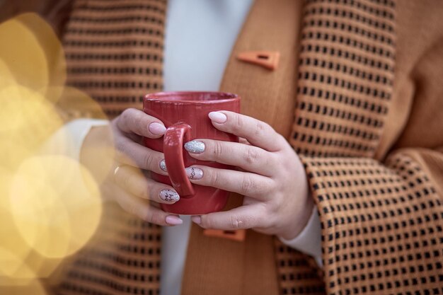 Hot beverage with marshmallows in female hands close up Christmas holidays mood