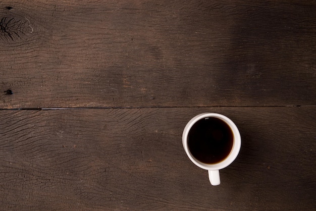 hot black coffee on office wooden table. good fresh morning begin of the day.