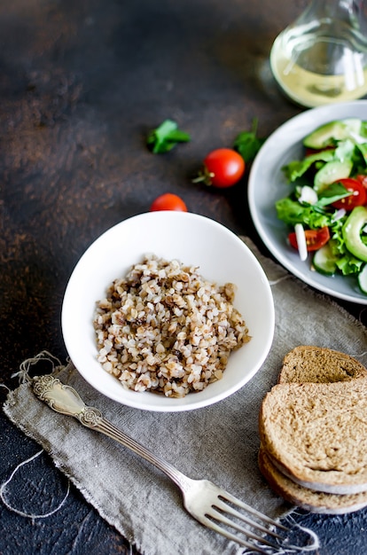 Hot buckwheat porridge with melting butter in plate