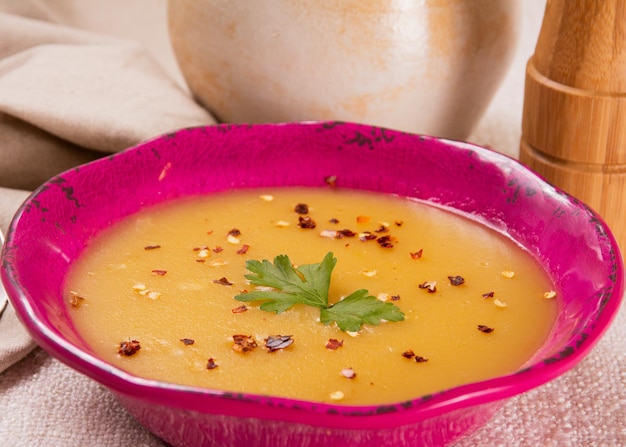 Hot cassava cream broth in a pink bowl