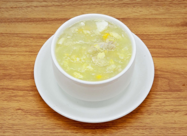 Hot chicken corn soup served in a bowl isolated on grey background side view of indian pakistani food