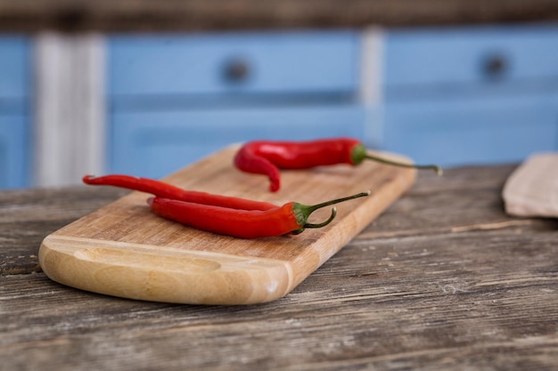 Hot chili peppers on cutting board