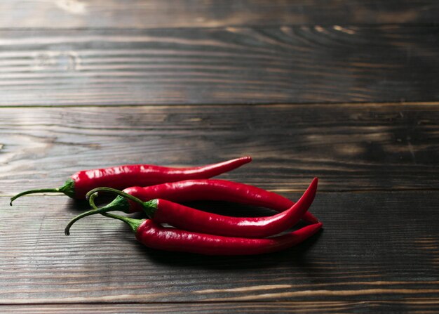 Hot chili peppers on a dark wooden background