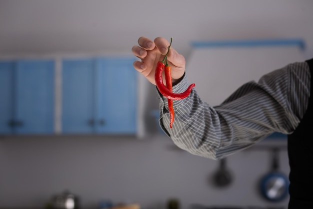 Hot chili peppers in mans hand