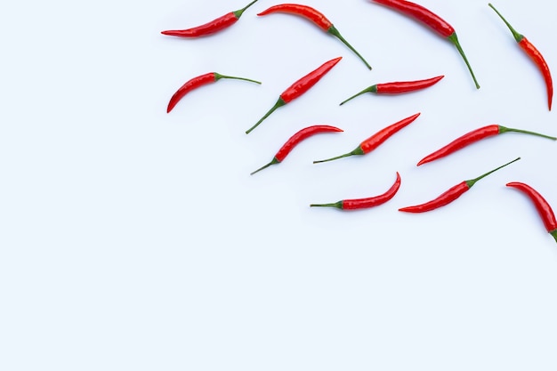 Hot chili peppers on white wall. Top view