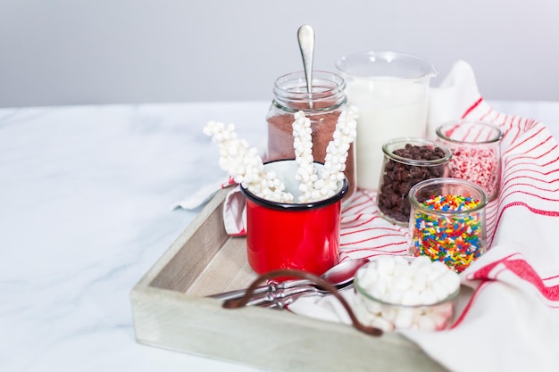 Hot chocolate bar with variety of topping on the tray .