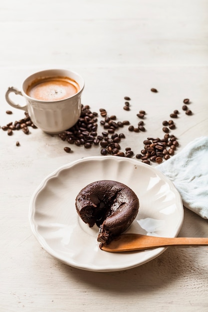 Суфле с горячим шоколадным тортом на тарелке с кофе и обжаренными кофейными зернами