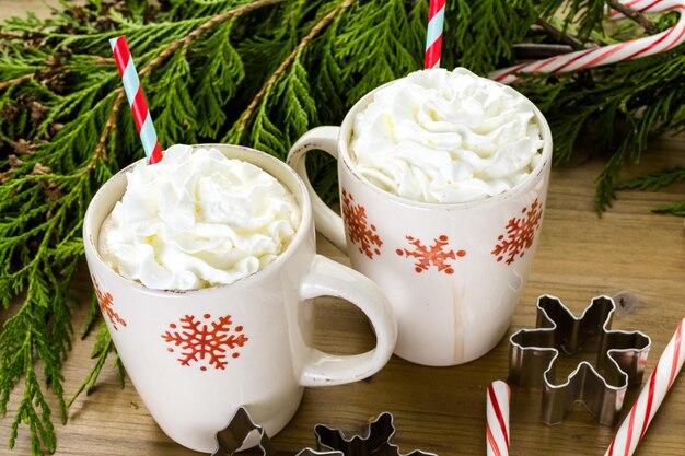 Hot chocolate garnished with whipped cream and straw.