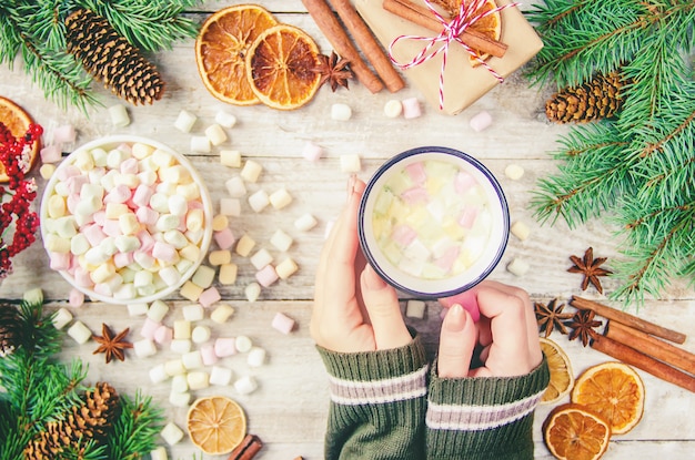 Hot chocolate and marshmallow on christmas background. Selective focus.