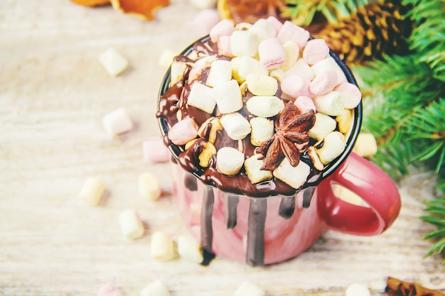 Hot chocolate and marshmallow on christmas background. Selective focus.