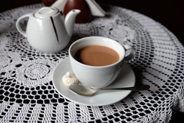 Hot chocolate in mug on table on dark background