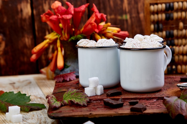 Hot chocolate with marshmallow candies on wood