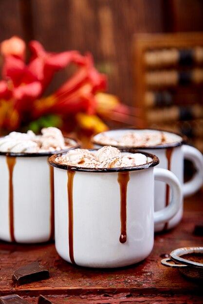 Hot chocolate with marshmallow candies on wooden.