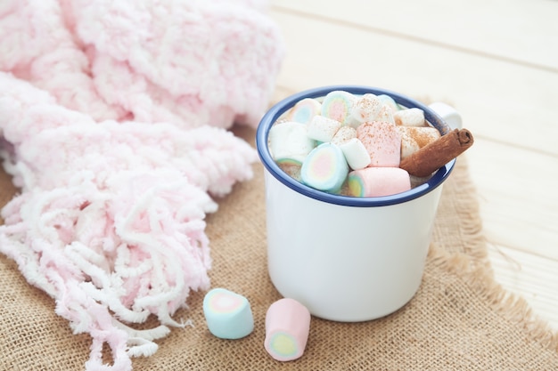 Hot chocolate with marshmallow and cinnamon stick. Winter lifestyle.