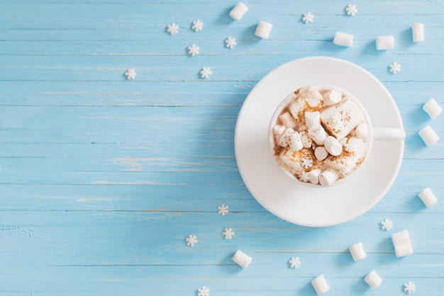 Hot chocolate with marshmallow on wooden background