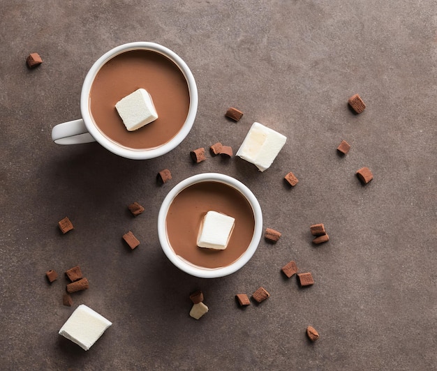 hot chocolate with marshmallows and marshmallow on a gray background top view flat lay