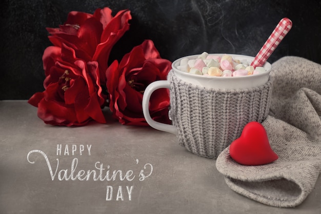 Hot chocolate with marshmallows, red heart on the cup on the tab