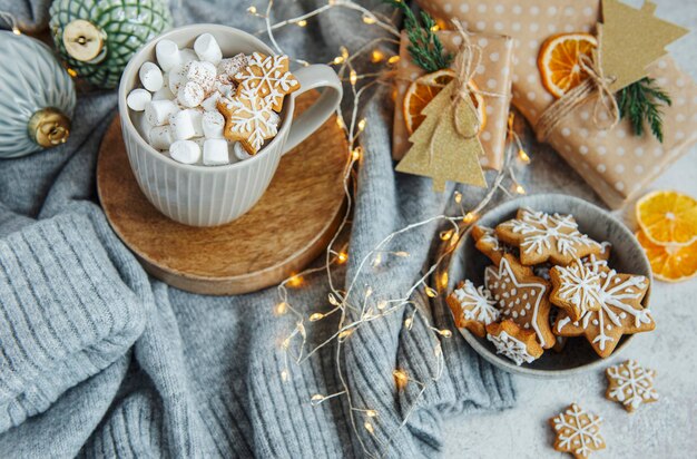 Hot chocolate with marshmallows, warm cozy Christmas drink, gingerbread cookies and decorations