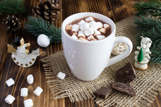 Hot chocolate with  marshmallows in the white cup on the rustic