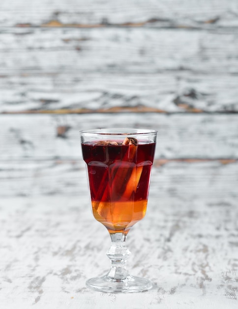 Hot cocktail of red wine honey and cinnamon On a wooden background Top view Free copy space