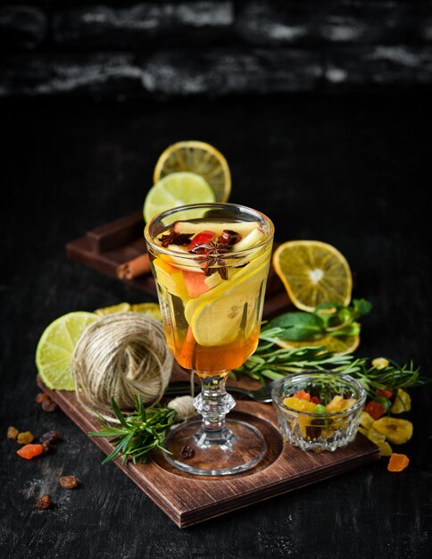 Hot cocktail of white wine honey and lemon On a wooden background Top view Free copy space