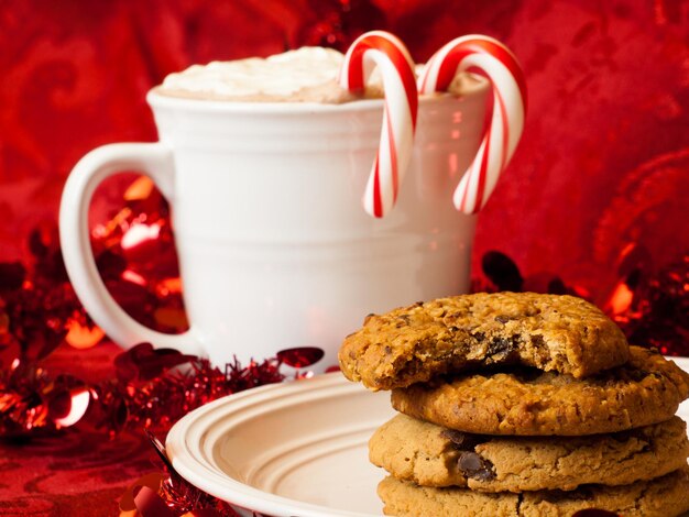 Photo hot cocoa with candy canes and few cookies.