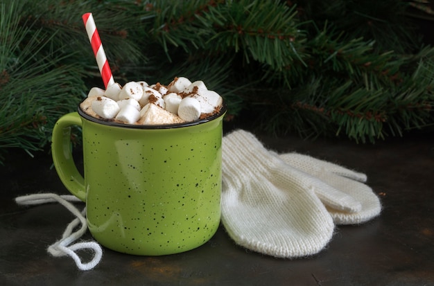 Hot cocoa with marshmallow in a green Cup