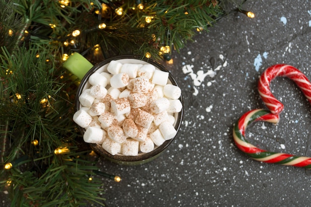 Hot cocoa with marshmallow in a green Cup