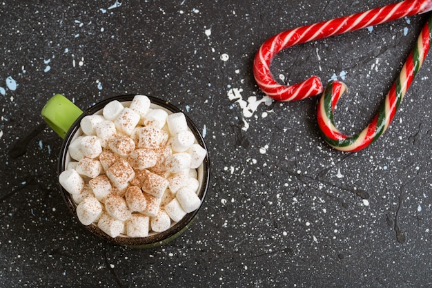 Hot cocoa with marshmallow in a green Cup