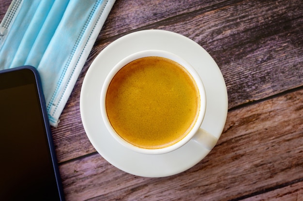 Hot coffee americano on the old wooden table