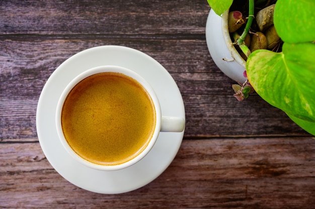 Photo hot coffee americano on the old wooden table