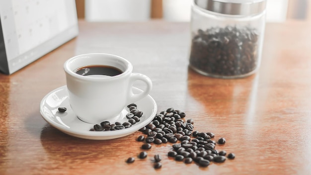 Hot coffee americano on the old wooden table.