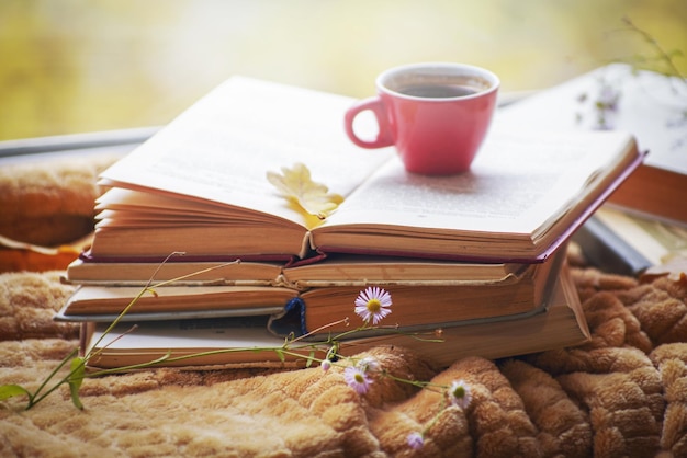 Hot coffee in the background of a window and autumn nature