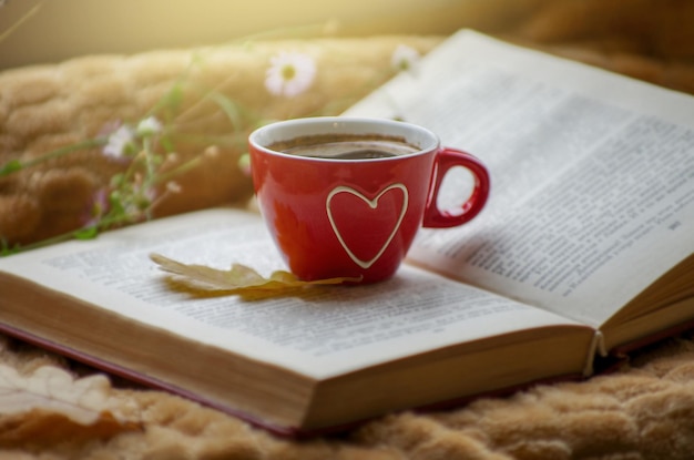 Hot coffee in the background of a window and autumn nature