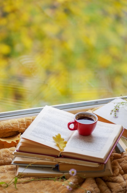 Hot coffee in the background of a window and autumn nature