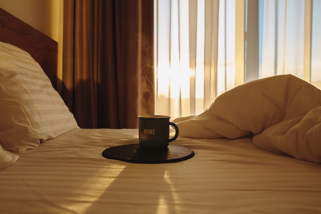 hot coffee in bed waking up with hot coffee in a white bed the sun shines into the bedroom