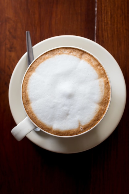 Hot coffee in ceramic glass on wood table