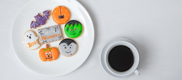 Hot coffee cup with funny Halloween Cookies Happy Halloween day Trick or Threat Hello October fall autumn Traditional party and holiday concept