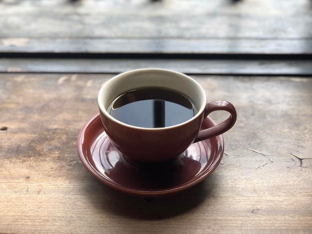 Hot coffee cup on wooden table