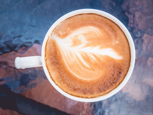 Hot coffee latte art on table