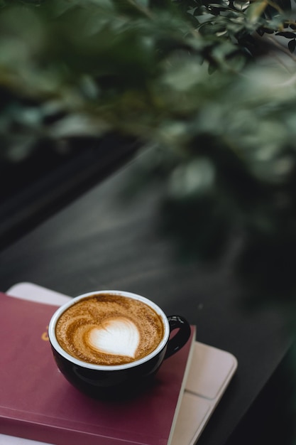 hot coffee latte and red book