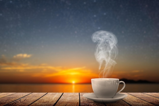 Photo hot coffee on the table against the background of the sea dawn