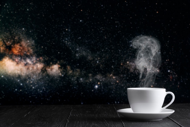 Hot coffee on the table on a night background