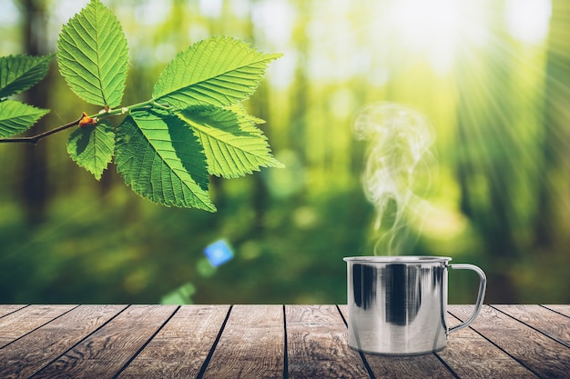 A hot coffee on the table on a spring background