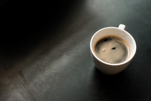 hot coffee on a table with cream being poured into it showing the texture