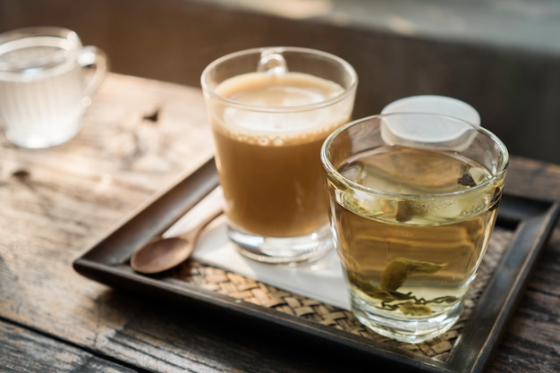 Hot coffee and tea on wooden table, Natural light 