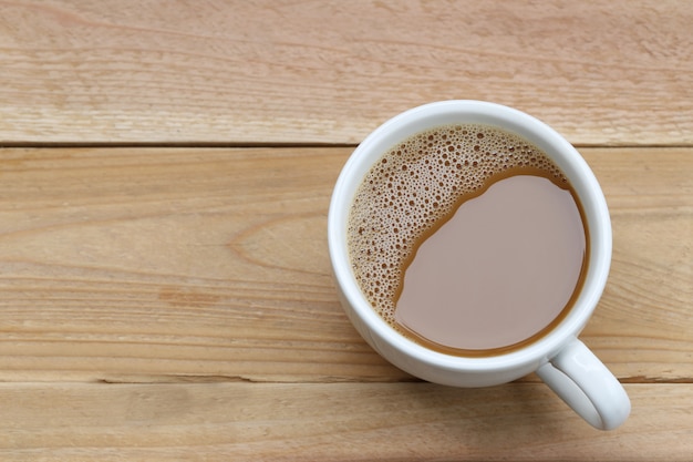 Hot coffee in a white Coffee cup on wooden table.